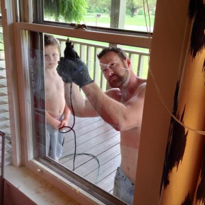 men repairing window