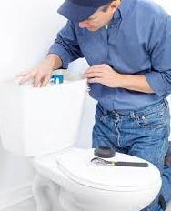 man fixing toilet